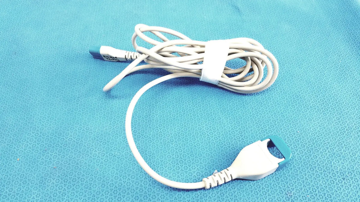 White spacelabs medical extension adapter cable 700-0030-00 with blue-tipped connectors coiled and secured by strap