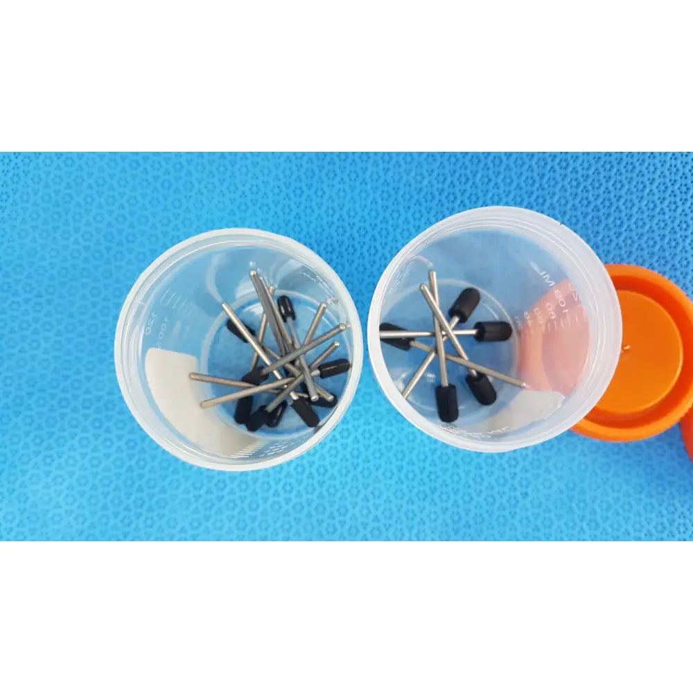Clear plastic specimen containers 90 ml sterile with tamper-evident label and orange cap holding black-tipped metal drill bits
