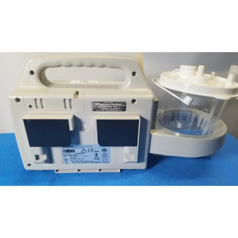 White plastic sscor duet suction unit with handle, two black panels, and clear container attachment model 2314b