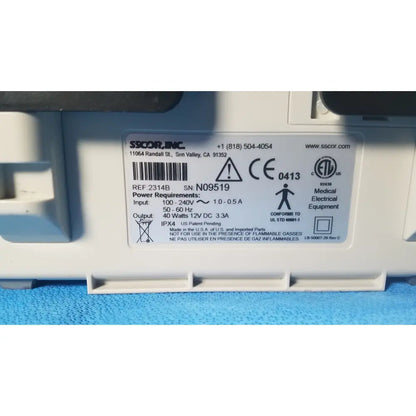 White plastic medical electrical equipment label with black text and certification marks on sscor duet suction model 2314b
