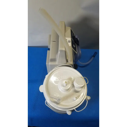 White plastic sscor duet suction unit with circular base and attached tubing model 2314b for medical use