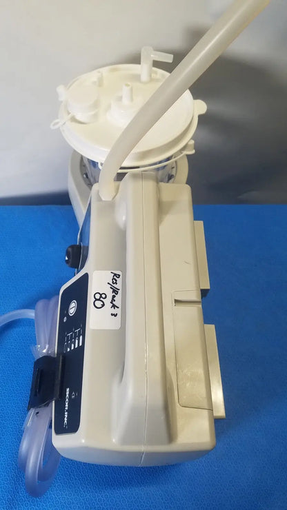 Beige plastic sscor duet suction unit model 2314b with white circular top and attached tubing for surgical use