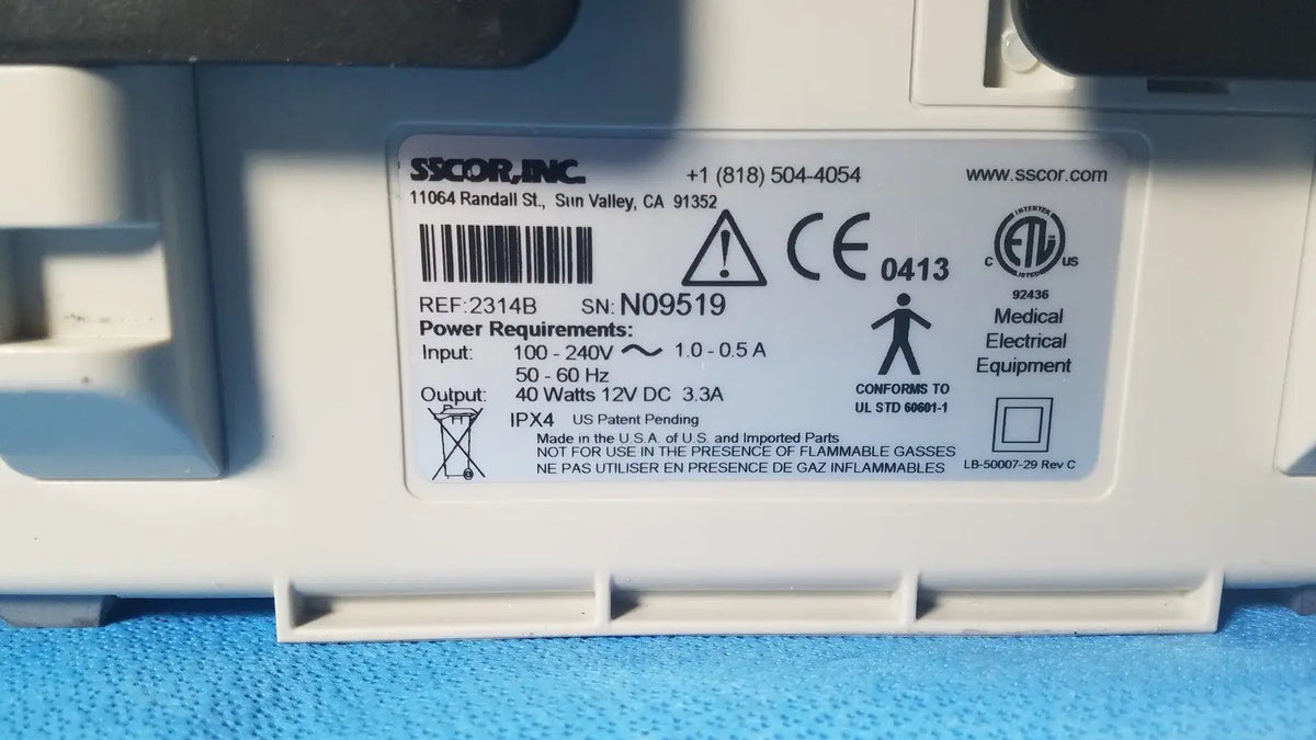 White plastic medical electrical equipment label with black text and certification marks on sscor duet suction model 2314b
