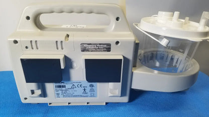 White plastic sscor duet suction unit with handle, two black panels, and clear container attachment model 2314b