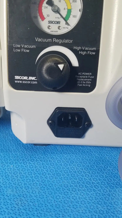 White plastic vacuum regulator with black control dial and power port on sscor duet suction unit model 2314b back side