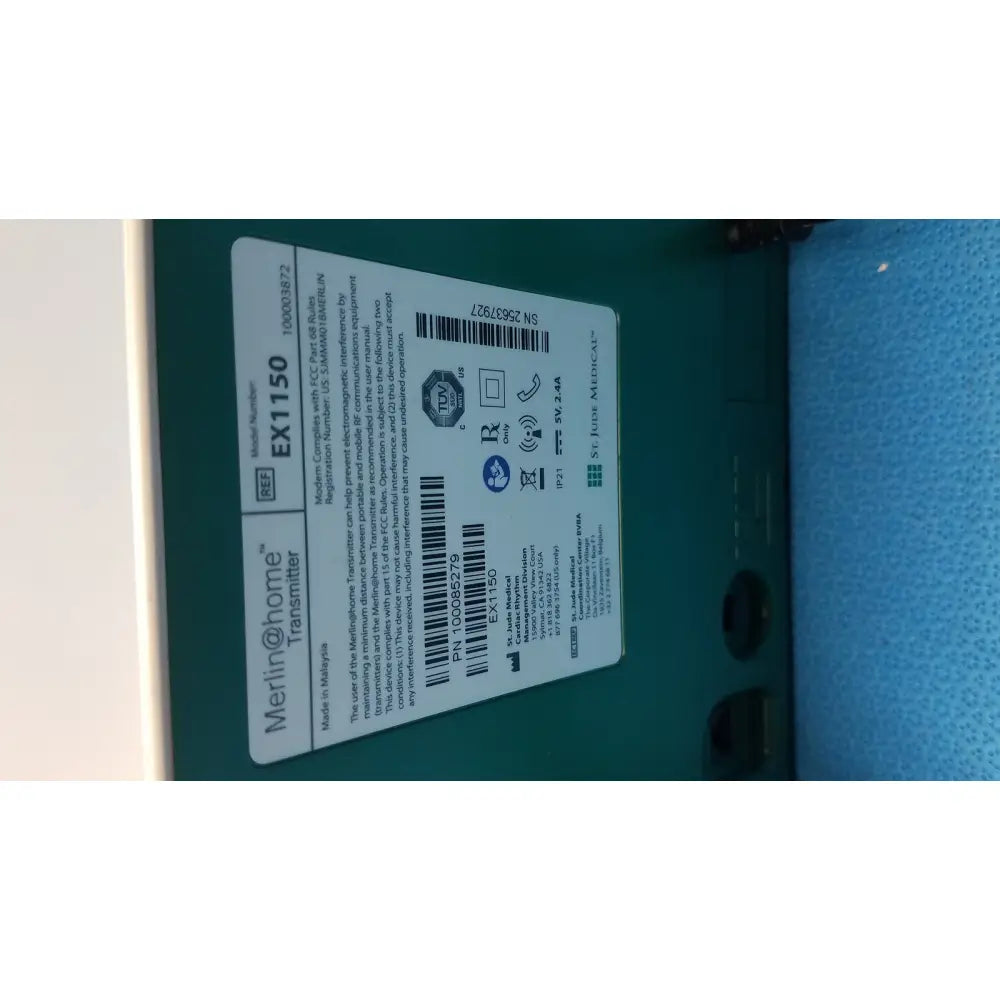 Green plastic St Jude EX1150 WiFi transmitter unit with white label and black text for wireless communication