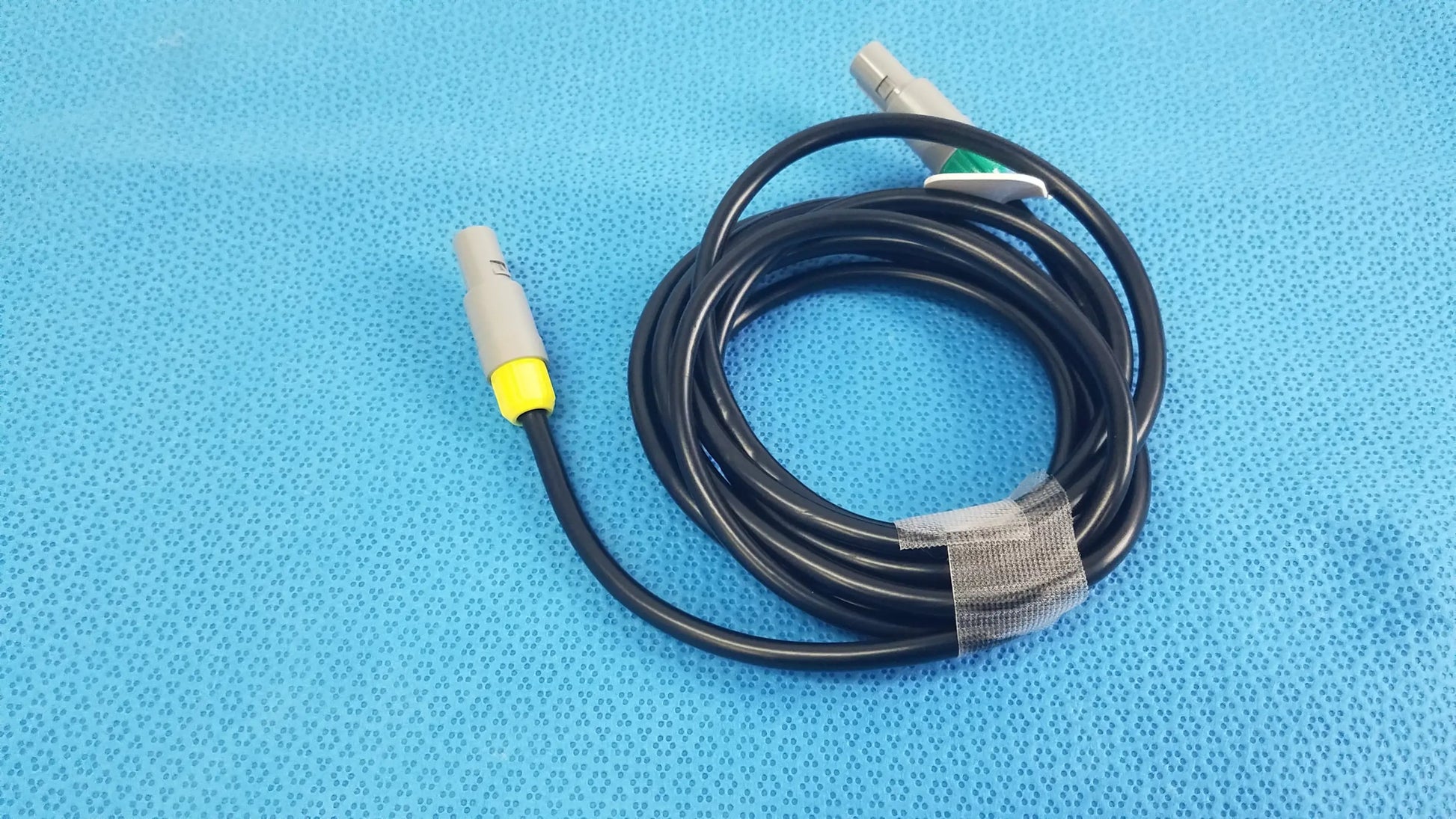 Black coiled St Jude Medical Ibi-85641 catheter connection cable with gray connectors and yellow accents for medical equipment reuse