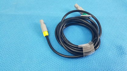 Black coiled St Jude Medical Ibi-85641 catheter connection cable with gray connectors and yellow accents for medical equipment reuse