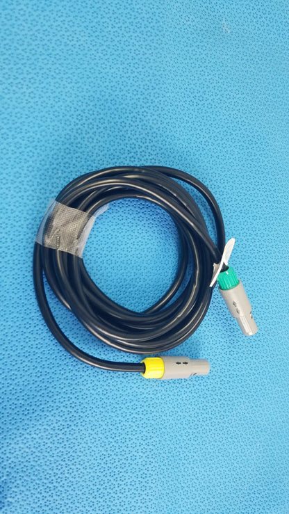 Black coiled catheter connection cable with gray connectors and green and yellow accents for reuse medical equipment