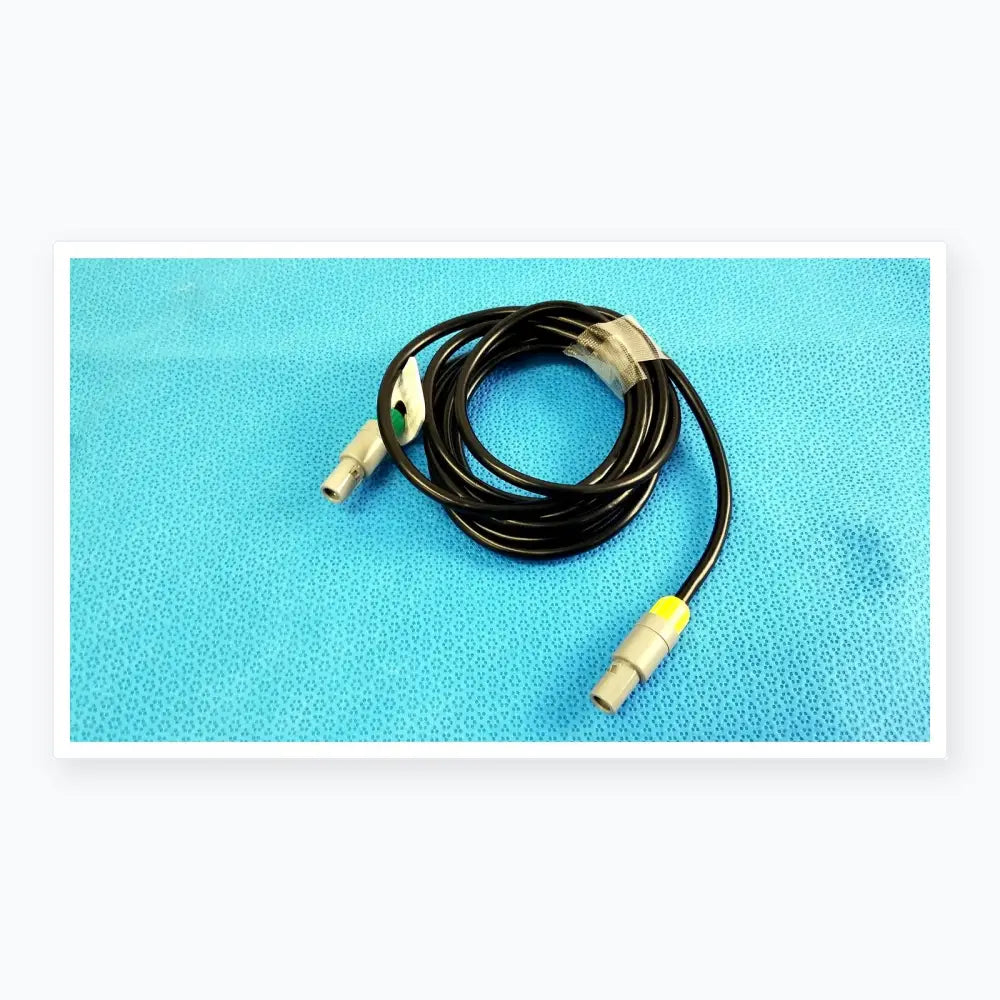 Black coiled catheter connection cable with gray connectors and yellow accent for reuse medical equipment by St Jude Medical