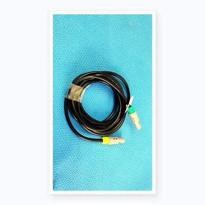 Black coiled catheter connection cable with gray connectors and green and yellow accents for reuse medical equipment