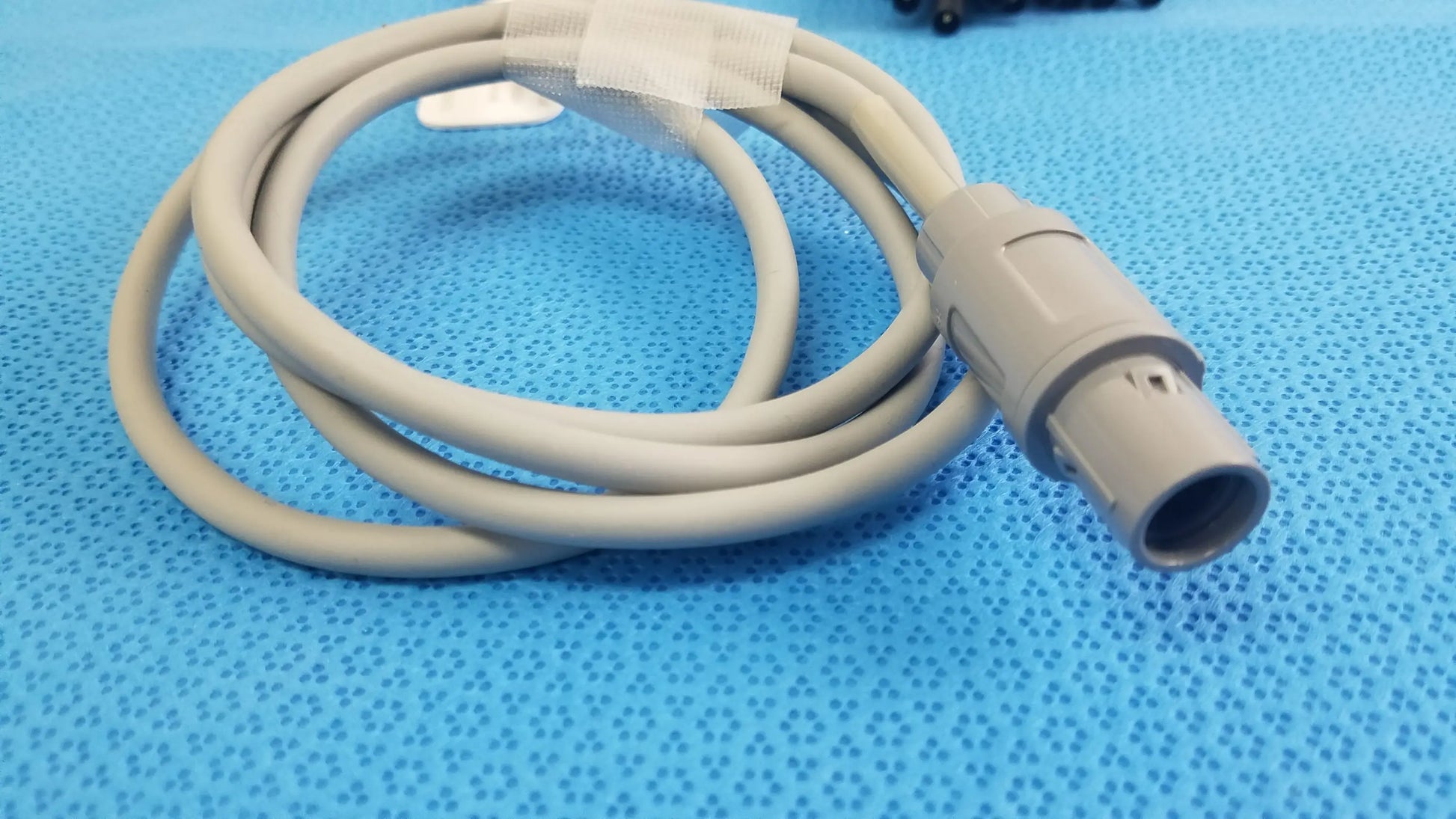 Beige medical-grade jude medical inquiry diagnostic connecting cable with molded plastic connector and protective tape