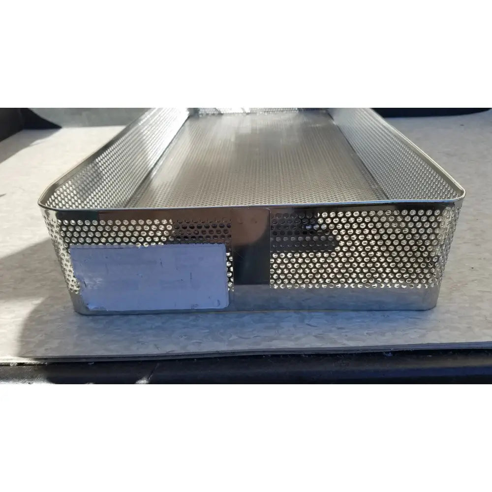 Rectangular stainless steel instrument sterilization basket tray with solid base and perforated sides for steel instrument sterilization