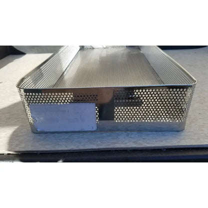Rectangular stainless steel instrument sterilization basket tray with solid base and perforated sides for steel instrument sterilization