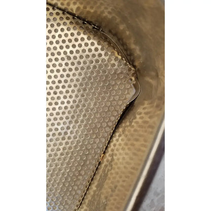 A metallic stainless steel sterilization basket tray with perforated textured surface and rounded edges