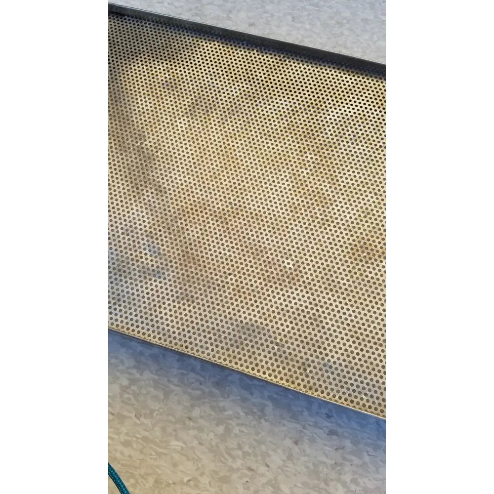 Stainless steel sterilization basket tray in rectangular perforated design with golden brown patina and circular holes
