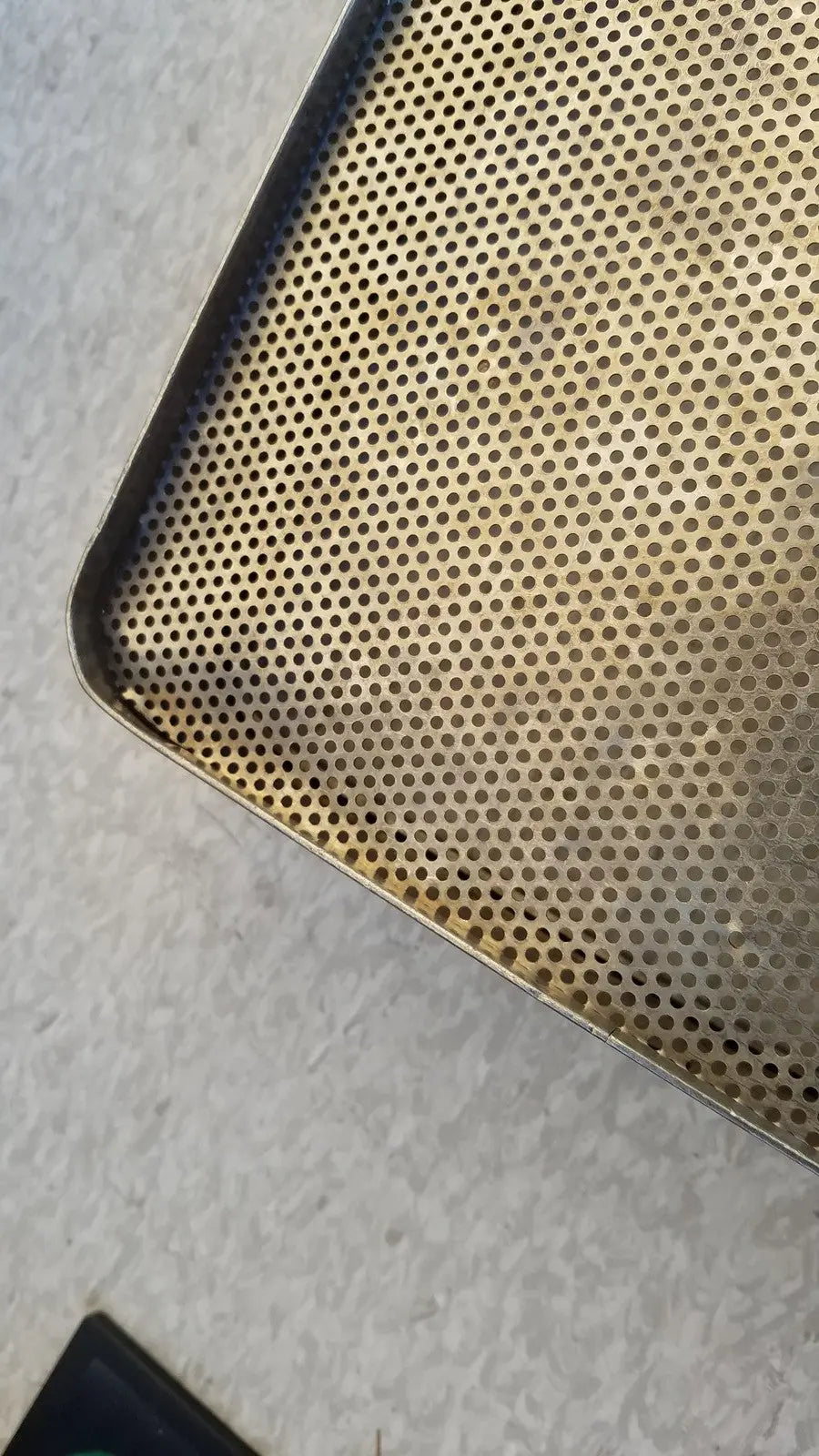 Gold-colored stainless steel sterilization basket tray with uniform perforated circular holes for effective sterilization