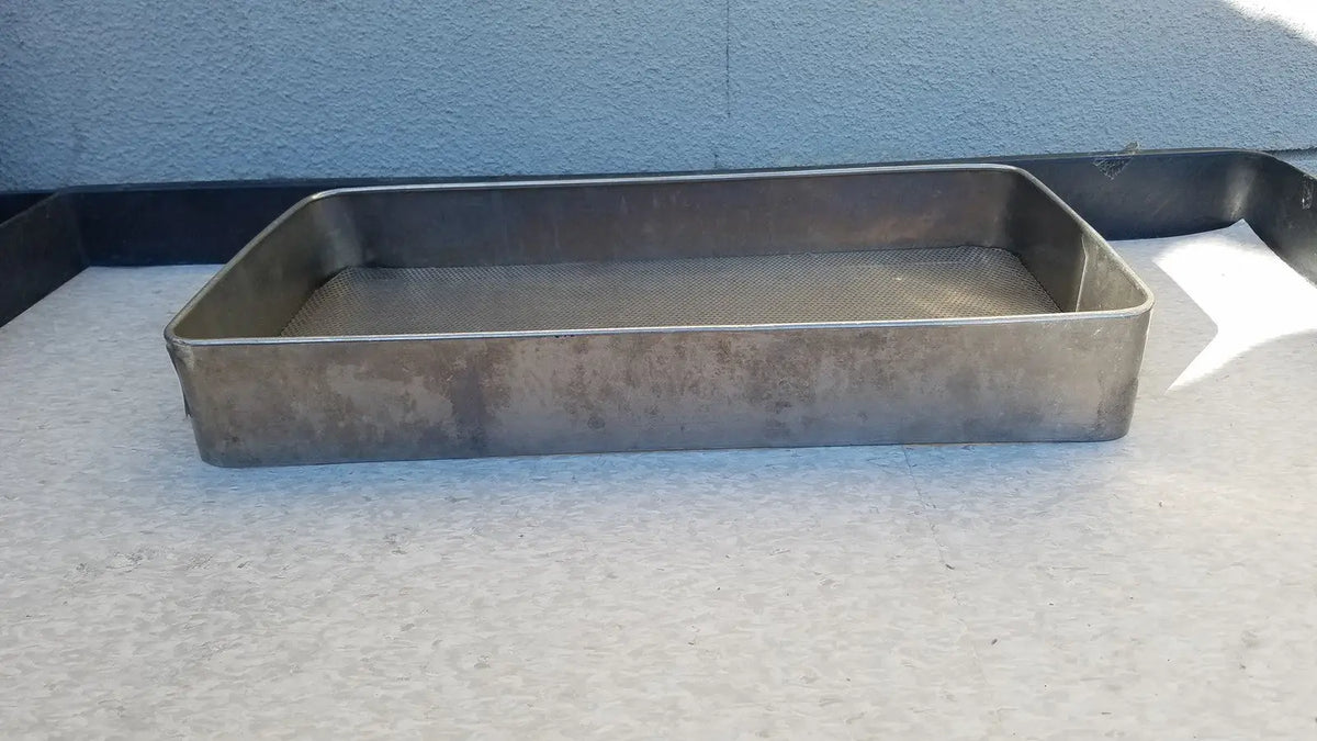 Rectangular stainless steel sterilization basket tray with mesh bottom and darkened surface for medical use