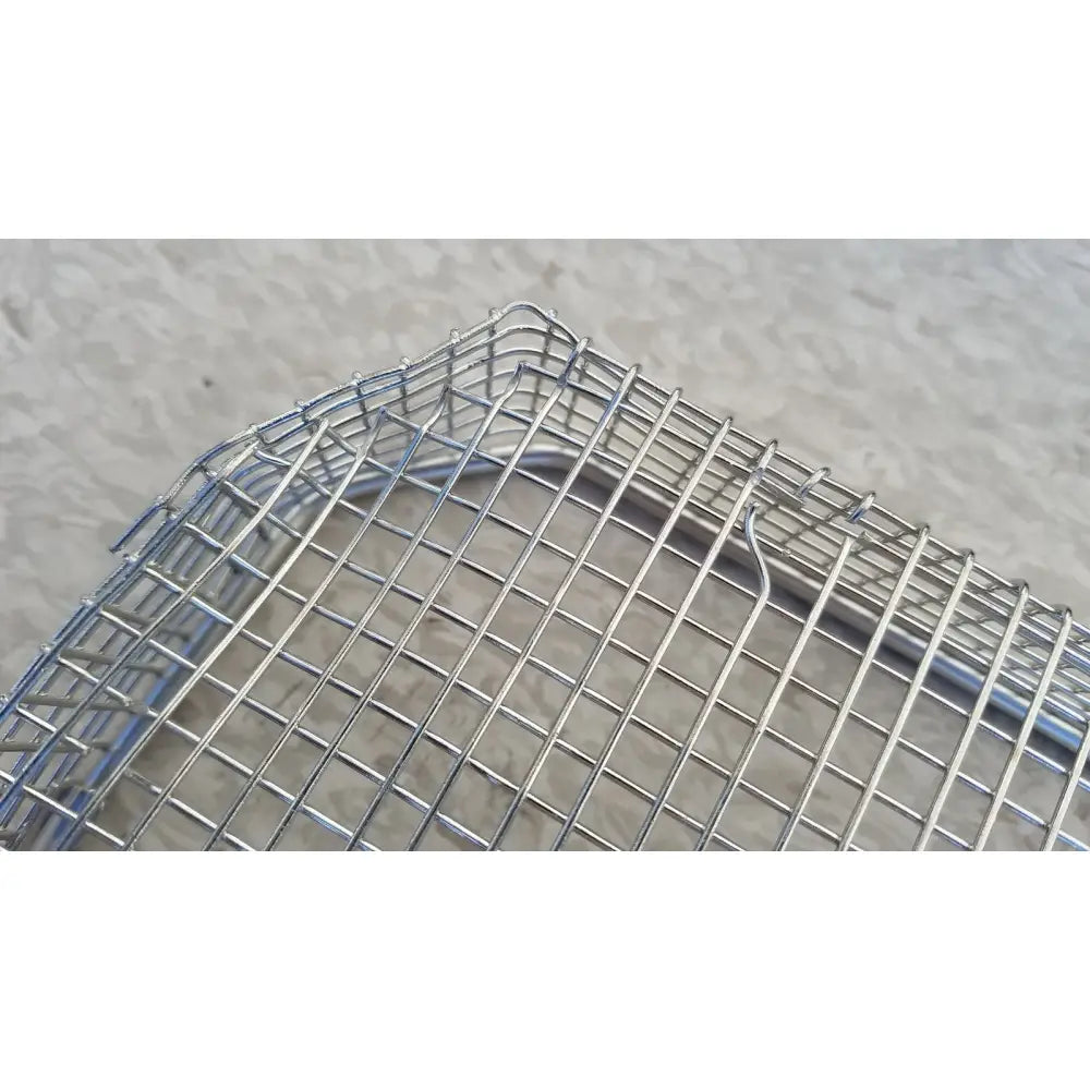 Silver wire mesh basket with rectangular grid and rounded corners for stainless steel sterilization surgical cases