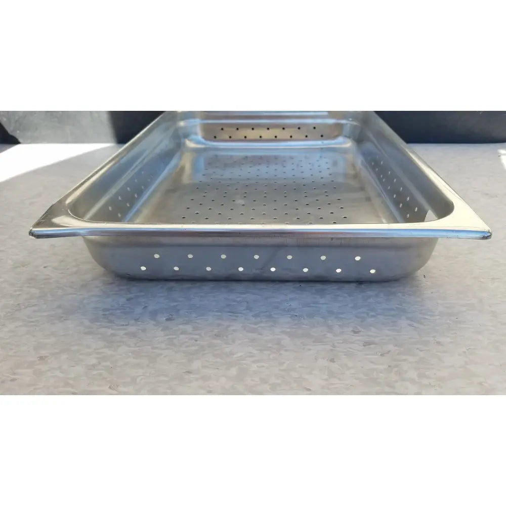 Rectangular stainless steel tray with evenly spaced perforations for draining and straining purposes
