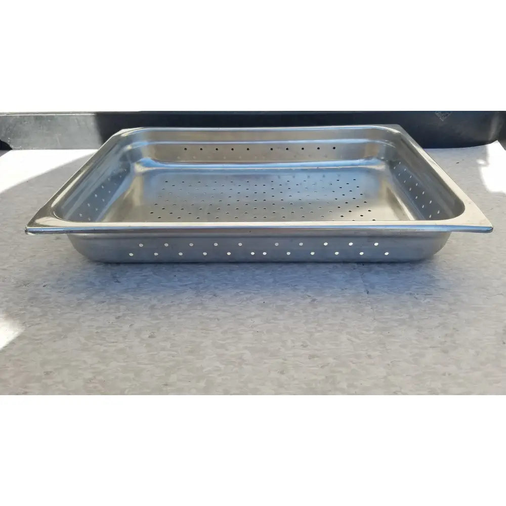 Rectangular stainless steel tray with holes featuring a shiny metallic finish and evenly spaced perforations