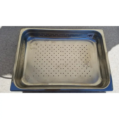 Rectangular stainless steel vollrath sheboygan tray with evenly spaced perforations for food service use