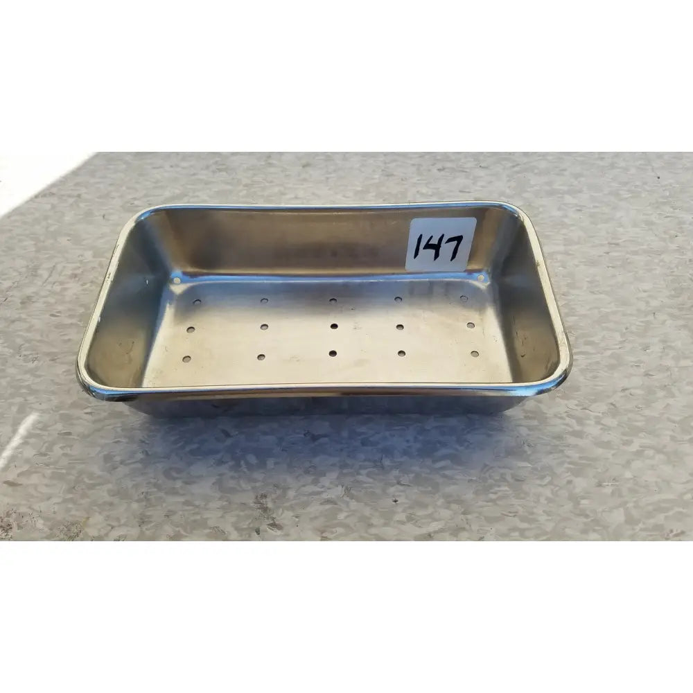 Rectangular stainless steel vollrath sheboygan tray case colander with perforations and white 147 label inside