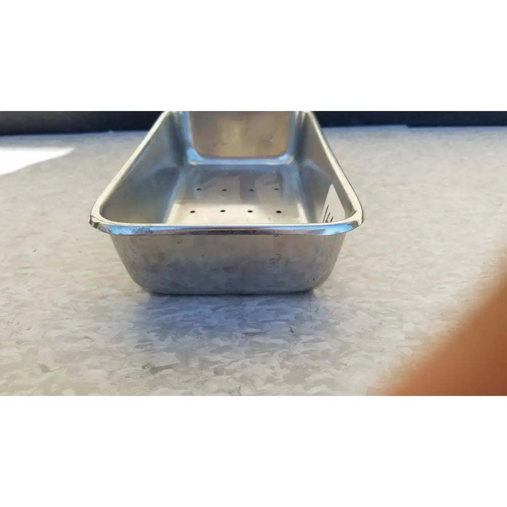 Rectangular stainless steel vollrath sheboygan tray with reflective surface and perforations for even baking
