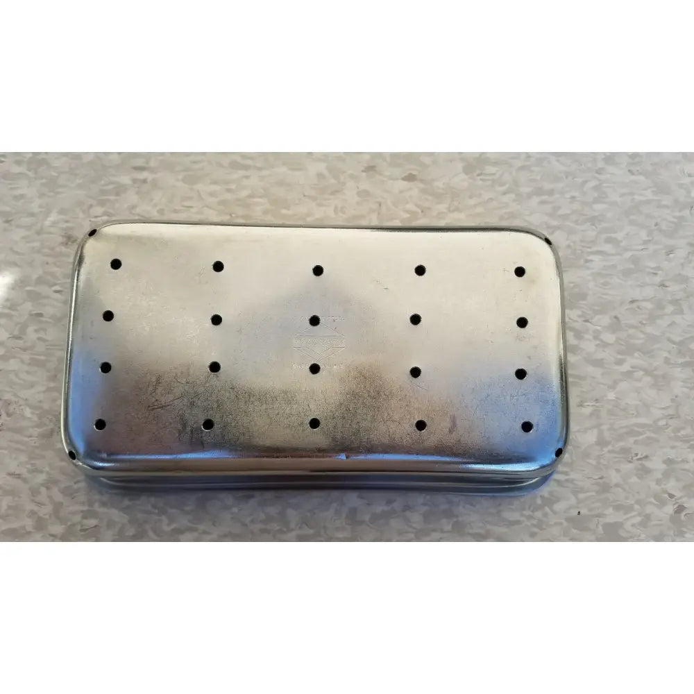 Rectangular silver metal soap dish with circular perforations in stainless steel vollrath sheboygan tray case