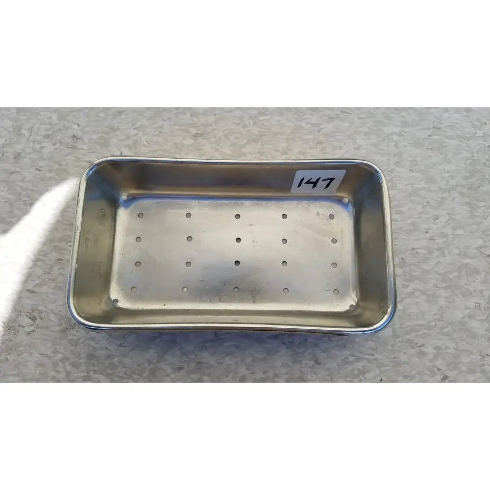 Rectangular stainless steel vollrath sheboygan tray case soap dish with perforations and white label marked 147