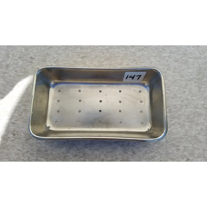Rectangular stainless steel vollrath sheboygan tray case soap dish with perforations and white label marked 147