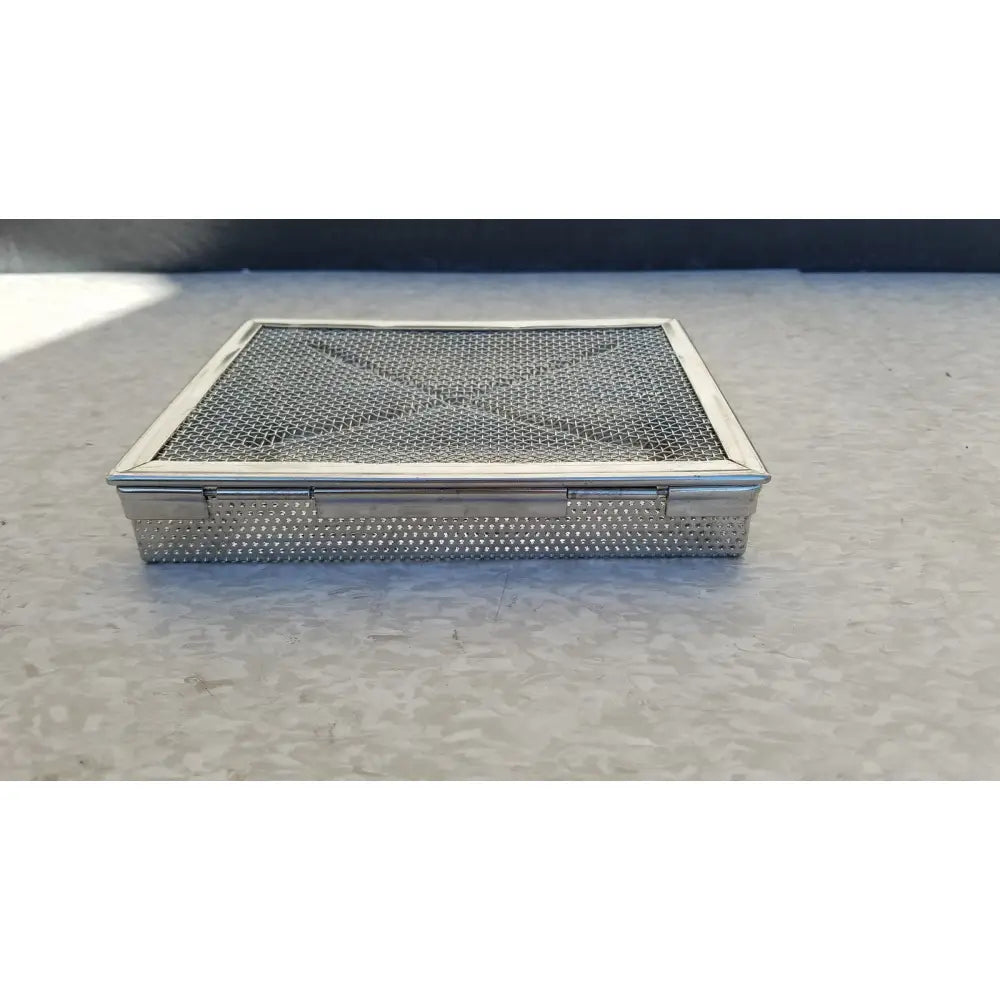 Silver mesh stainless surgical instrument box with hinged lid and perforated sides for sterilization use