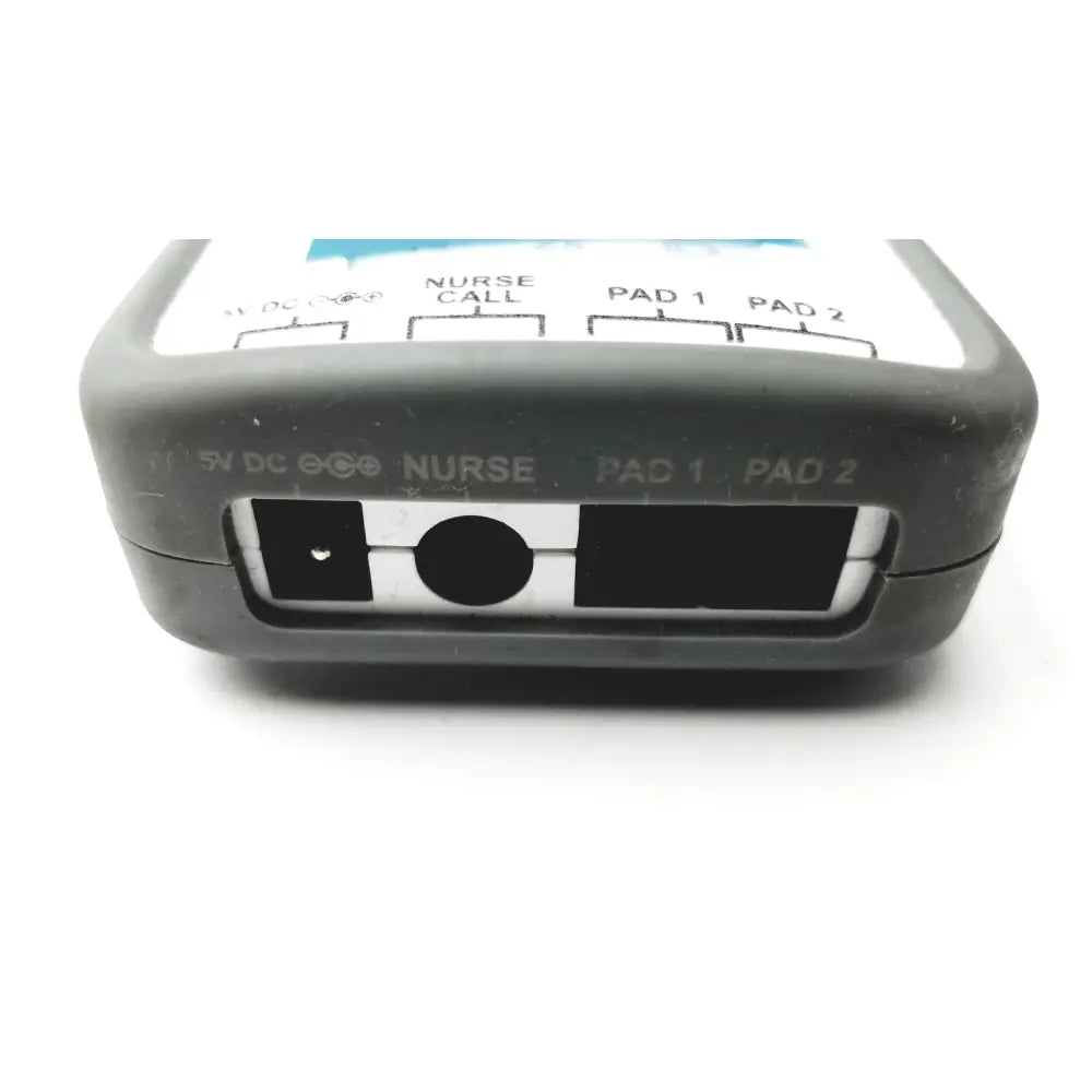 Gray plastic back side of stanley healthcare m200 nurse call unit with labeled ports for dc power nurse call and patient pads