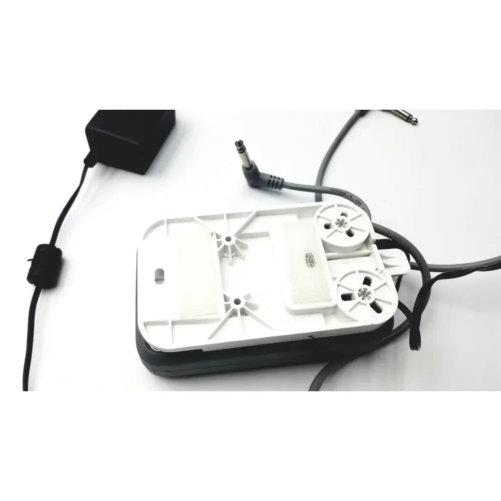 White plastic aquarium air pump with black base and power cord shown with stanley healthcare m200 nurse call unit extras