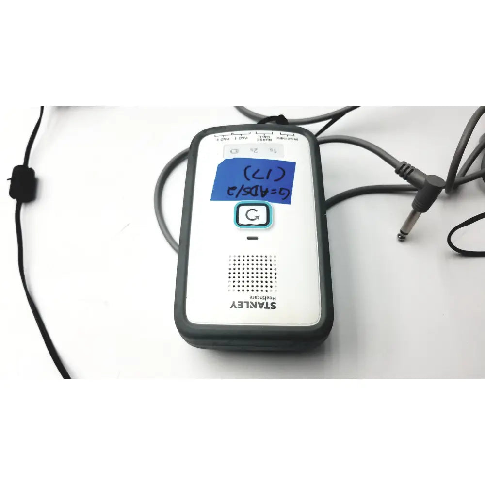 Stanley healthcare m200 nurse call unit portable audio device with black and white casing and blue sticky note on screen