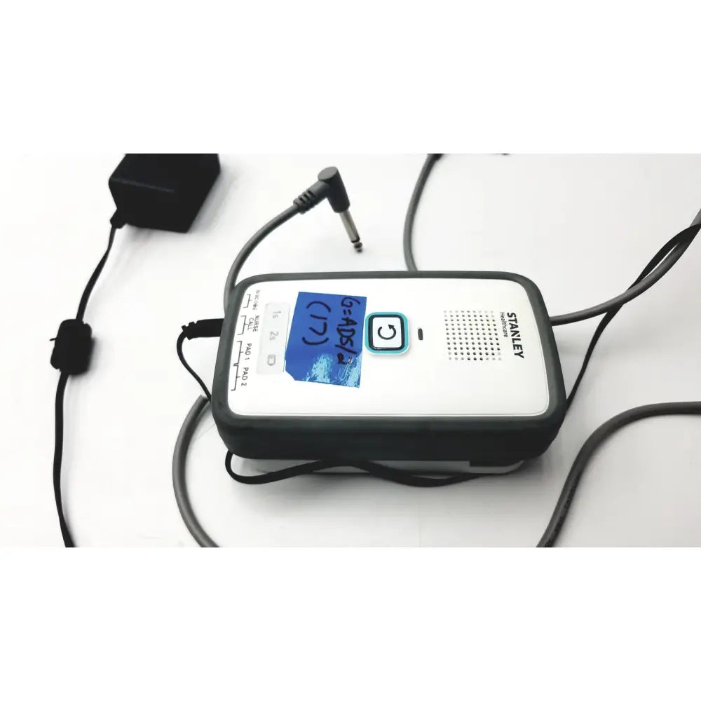 Stanley healthcare m200 nurse call unit portable speaker with black and white casing and circular button