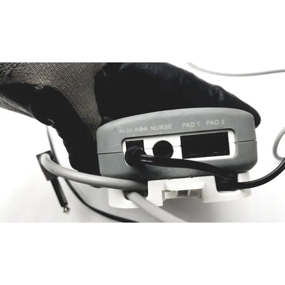 Gray plastic stanley healthcare m200 nurse call unit backside showing labeled ports for nurse and patient pads connectivity