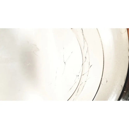 A cracked white ceramic plate with faint circular ridges and minor imperfections for statspin express m510 high-speed horizontal centrifuge