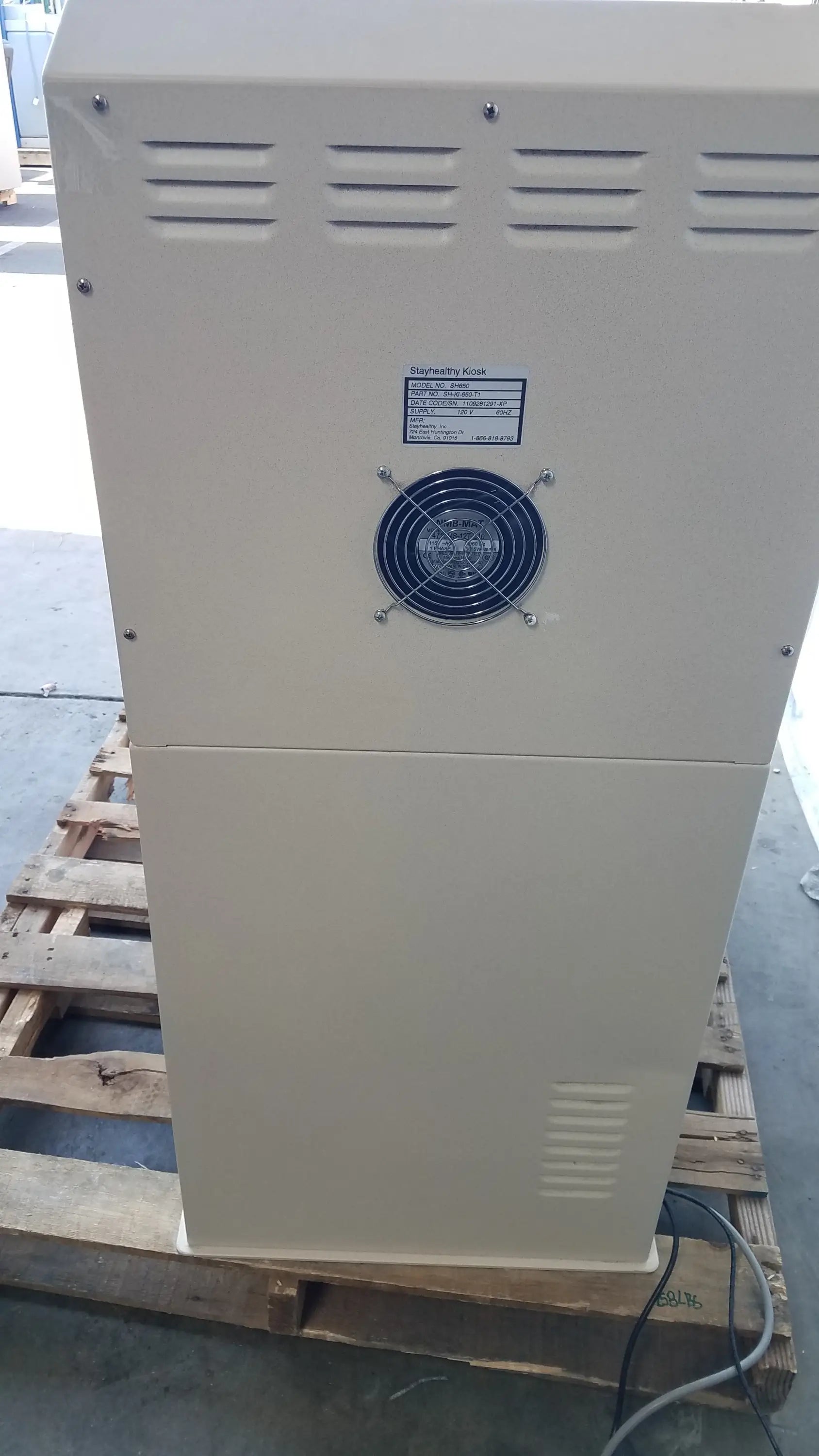 Beige industrial-grade electrical enclosure with blue fan and ventilation slits on the back of stayhealthy sh650 health screening kiosk