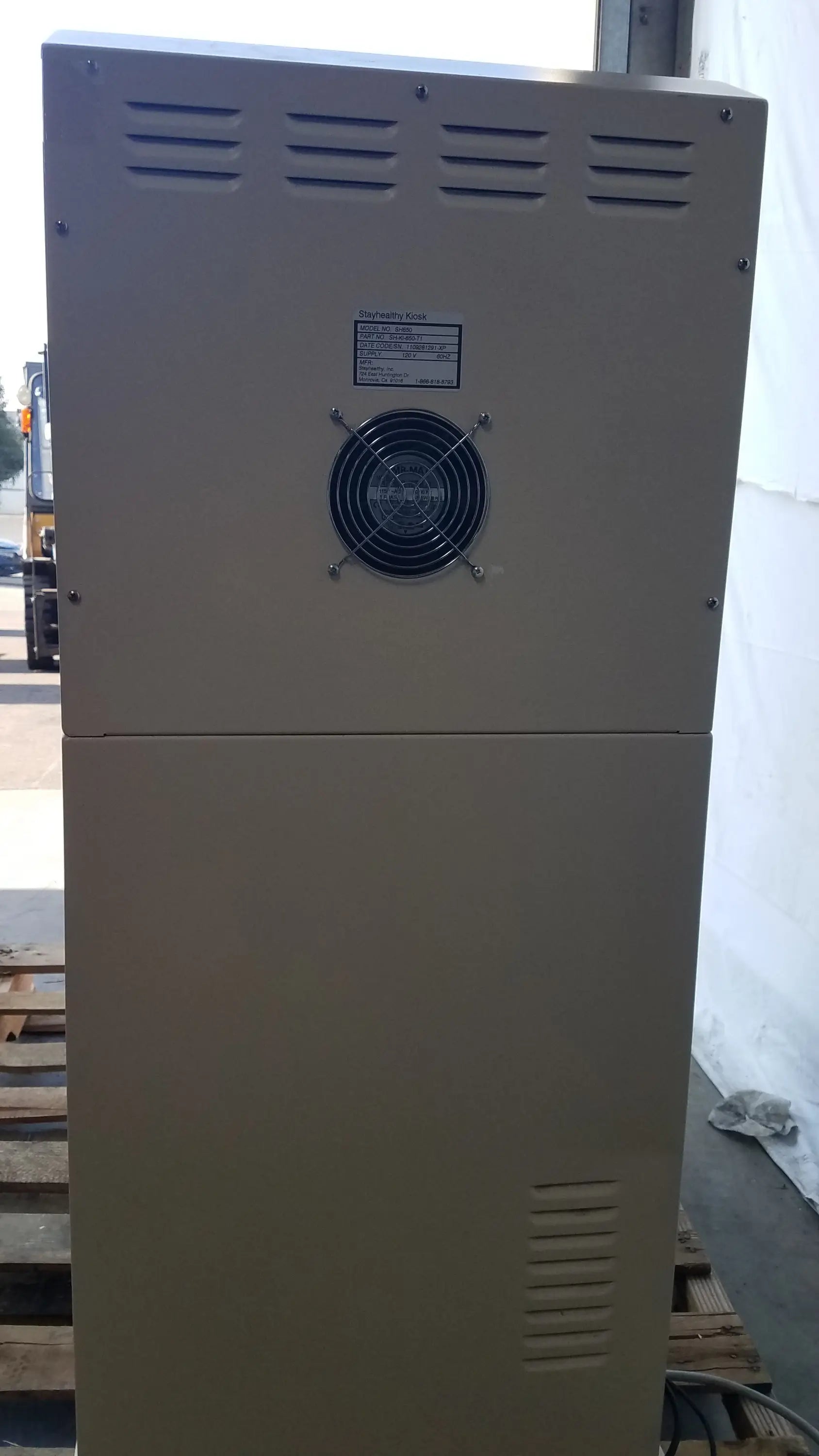Beige industrial-grade electrical cabinet with black fan and ventilation slits on back of stayhealthy sh650 health screening kiosk