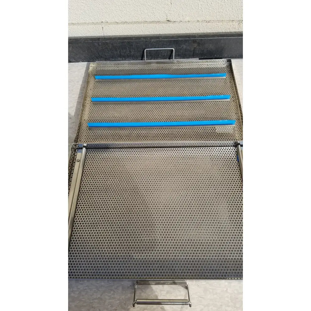 Sterilization case tray with stainless steel mesh and four horizontal blue plastic rods for surgical instruments