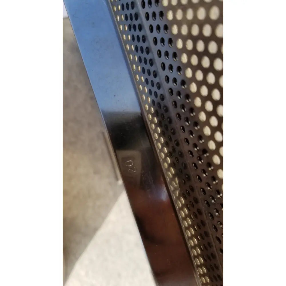 Shiny metallic edge with perforated pattern and engraved 02 marking on sterilization case tray for surgical instruments
