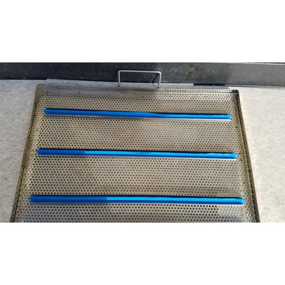 Stainless steel sterilization case tray with perforations and three horizontal blue plastic strips for surgical instruments