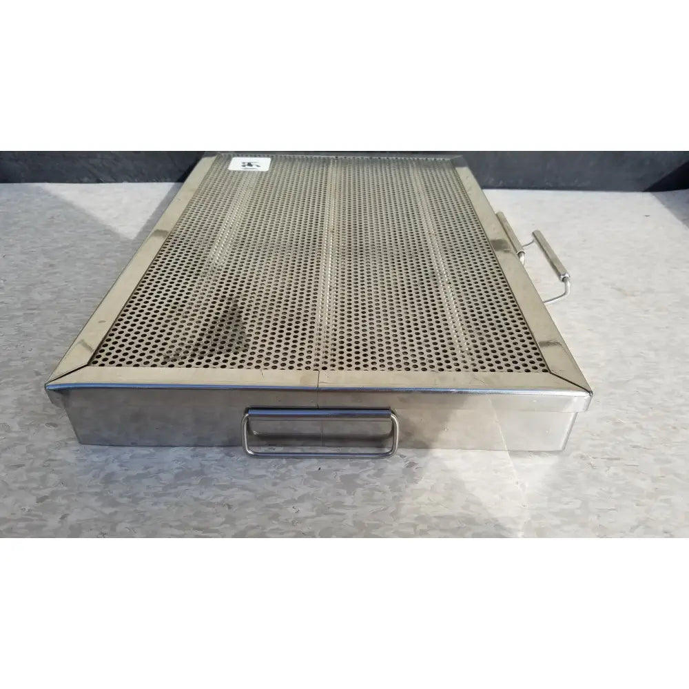 Rectangular stainless steel perforated sterilization case tray with handles on each side for surgical instruments