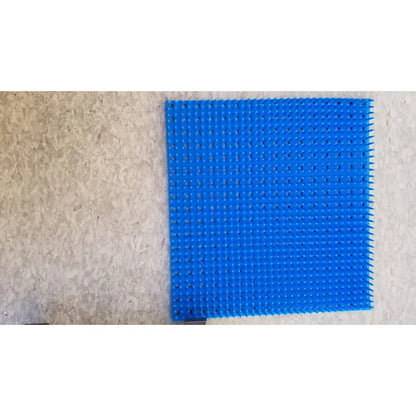 Bright blue plastic pegboard with raised bumps and holes for sterilization case silicone mat reuse medical use