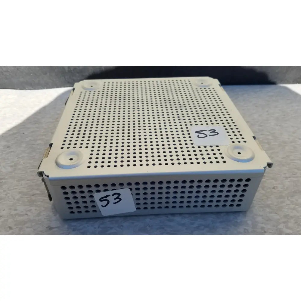 White perforated metal sterilization case with rounded corners and silicone mat for reuse medical instruments