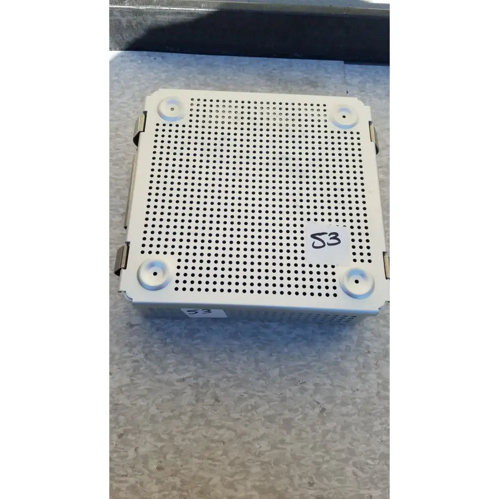 White perforated metal sterilization case with four corner latches and silicone mat for surgical instrument trays