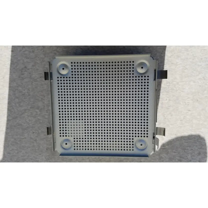 Gray perforated metal panel with four circular holes for mounting in sterilization case with silicone mat for reuse medical use