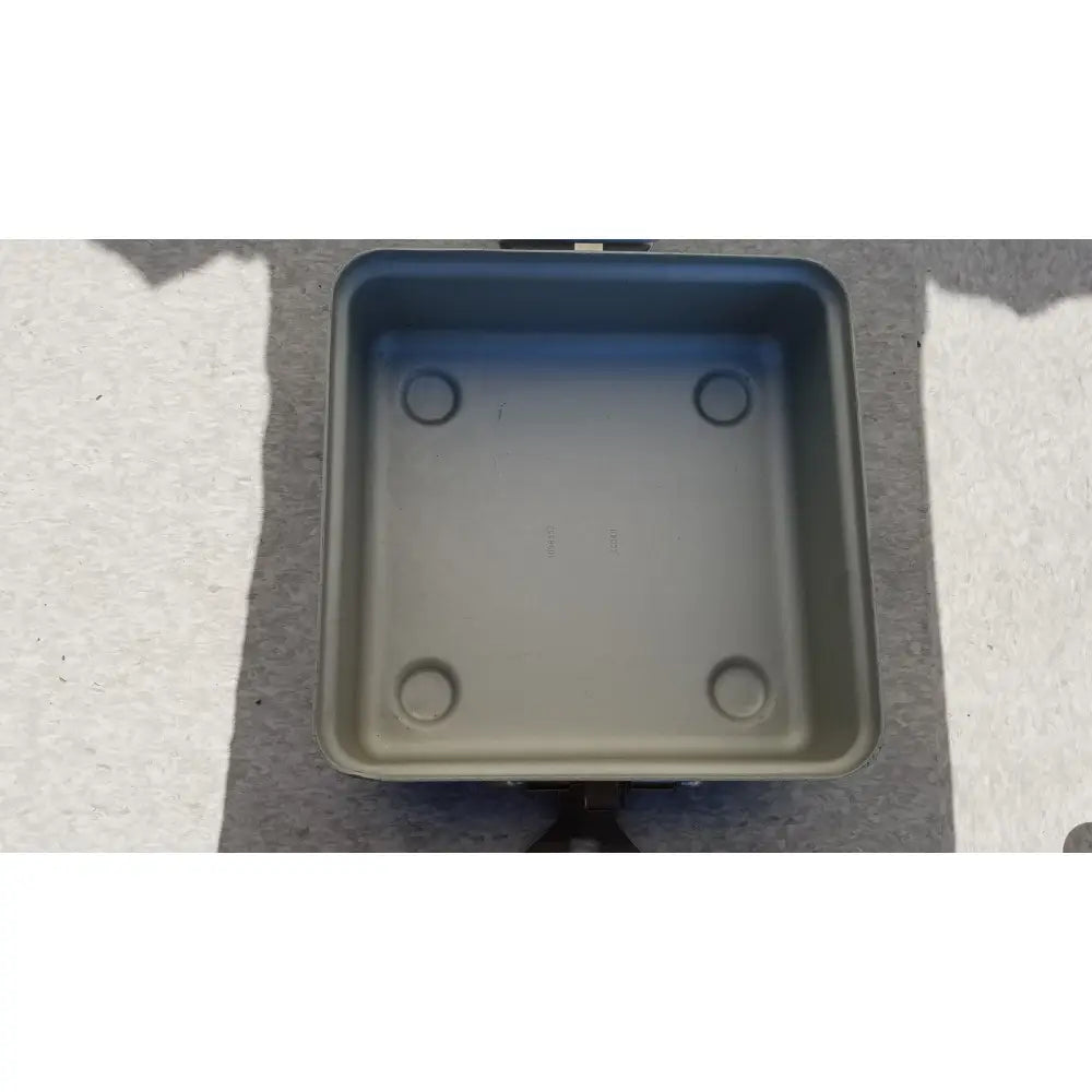 Gray square electric skillet with rounded corners and circular indentations designed for reuse medical sterilization trays