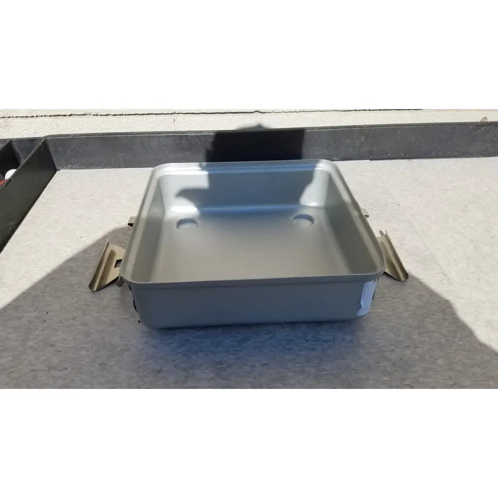 Silver rectangular metal sterilization container without lid featuring rounded corners and two circular indentations